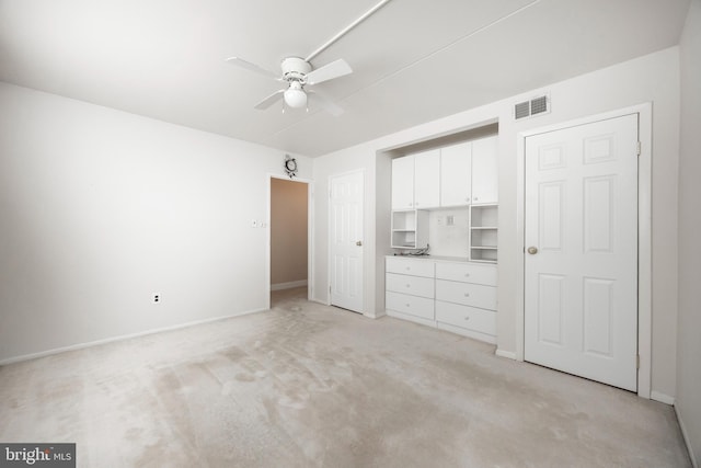 unfurnished bedroom with ceiling fan and light carpet