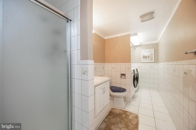 bathroom with crown molding, tile walls, vanity, washer / clothes dryer, and tile patterned floors