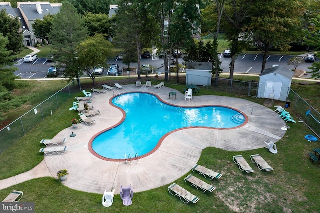 view of swimming pool featuring a yard and a patio