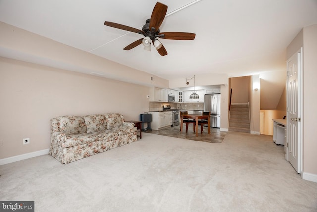 carpeted living room featuring ceiling fan