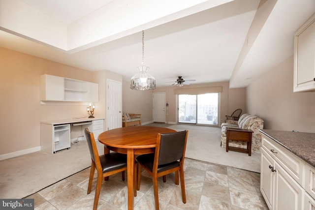 carpeted dining space with ceiling fan