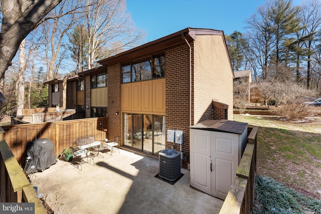 back of house with central air condition unit and a patio area