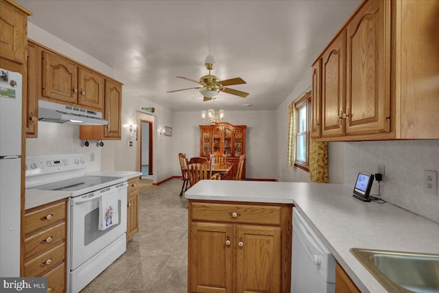 kitchen with under cabinet range hood, a peninsula, white appliances, light countertops, and decorative backsplash