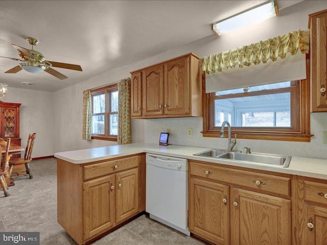 kitchen with a peninsula, light countertops, and dishwasher