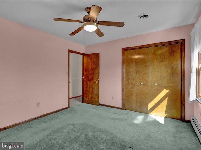 unfurnished bedroom featuring light carpet, baseboards, visible vents, a baseboard heating unit, and a closet