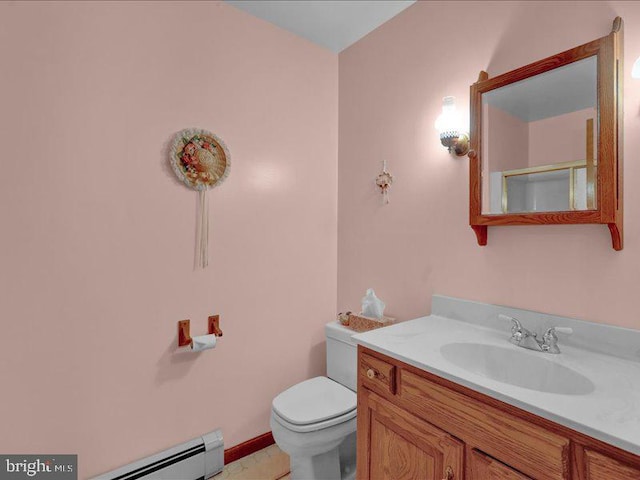 bathroom with a baseboard heating unit, vanity, and toilet