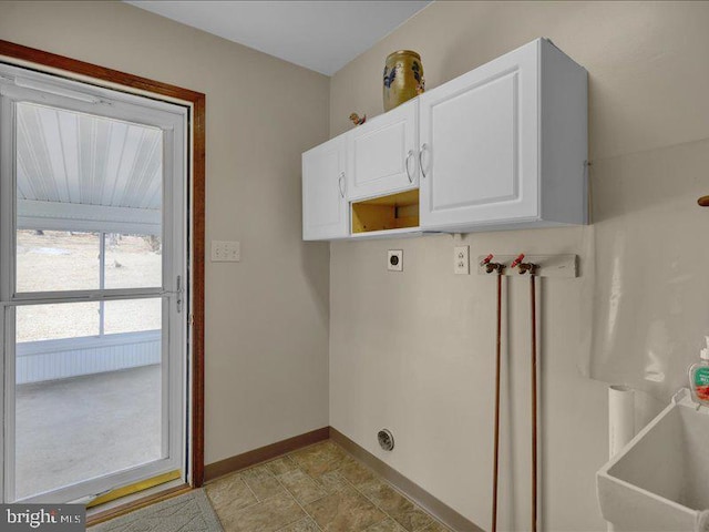 washroom with cabinet space, baseboards, and hookup for an electric dryer