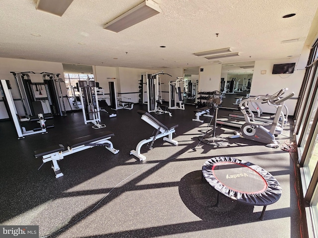 exercise room with a textured ceiling