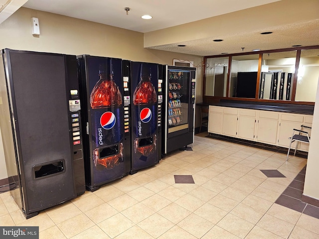 kitchen featuring white cabinets, a textured ceiling, black fridge, and fridge