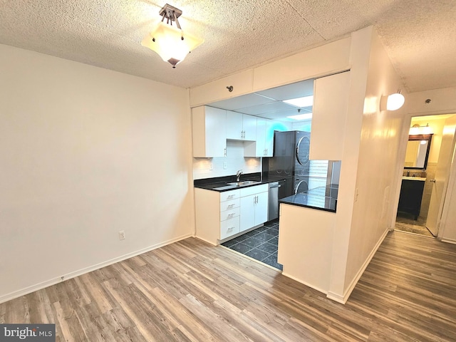 kitchen featuring white cabinets, wood-type flooring, sink, and dishwasher