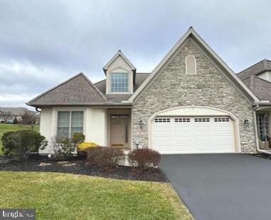 view of front facade with a front yard and a garage