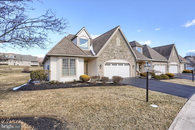 view of front of property with a front yard and a garage