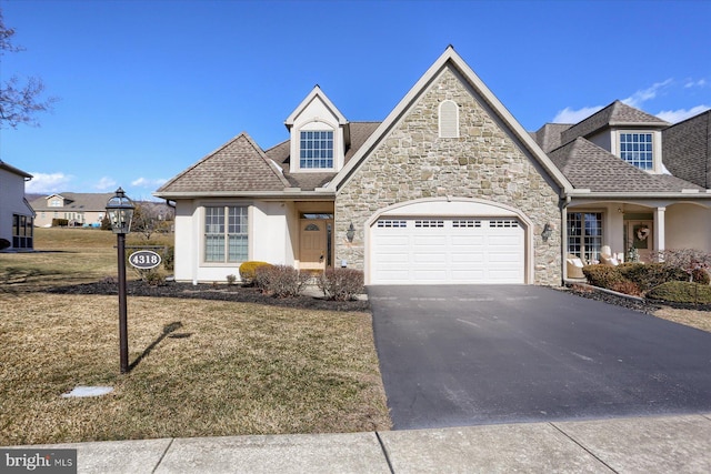 view of front of home with a garage and a front yard