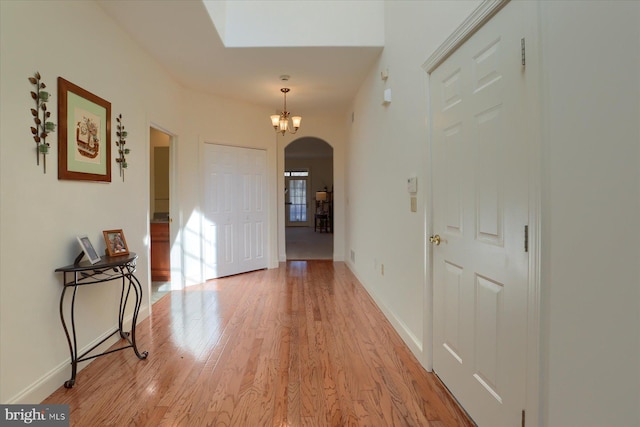 entrance foyer featuring light wood-type flooring and a chandelier