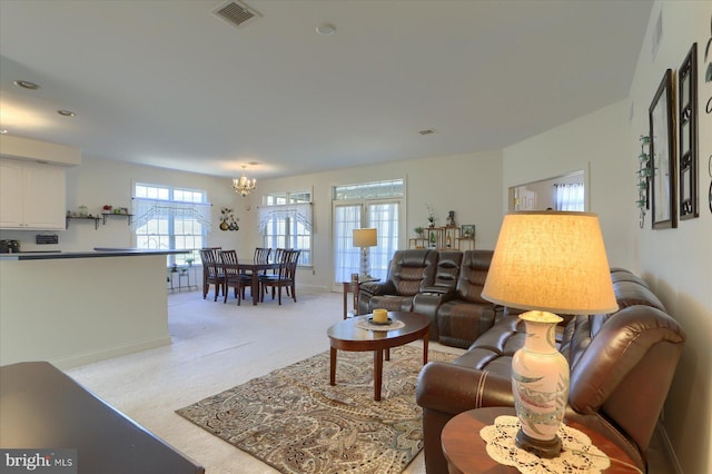 living room featuring a chandelier and light colored carpet