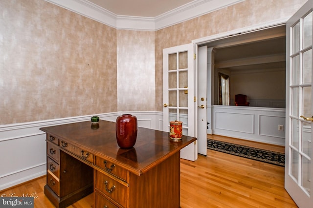 office area featuring light wood finished floors, french doors, wainscoting, and crown molding