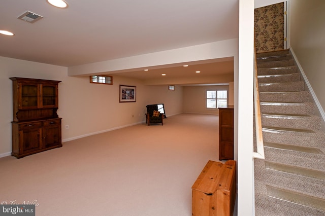 basement featuring carpet, visible vents, stairway, and recessed lighting