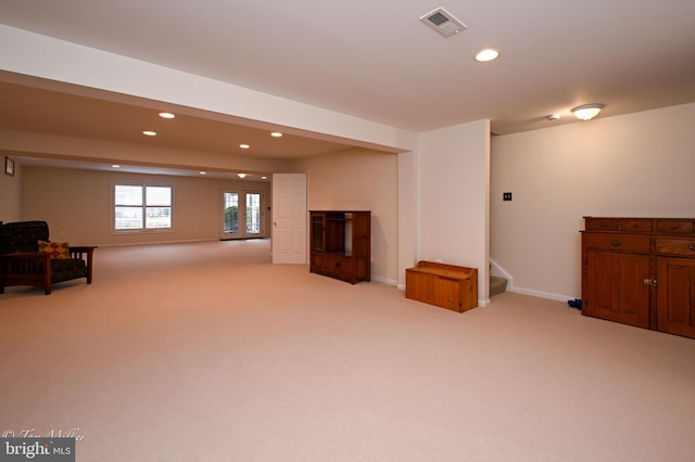 interior space with light carpet, stairway, visible vents, and recessed lighting