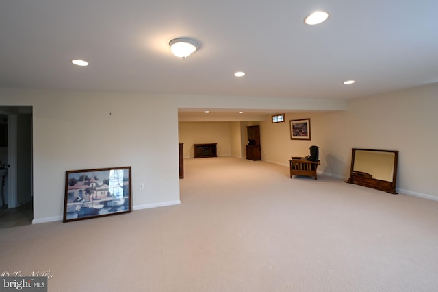 finished below grade area with recessed lighting, light carpet, and baseboards