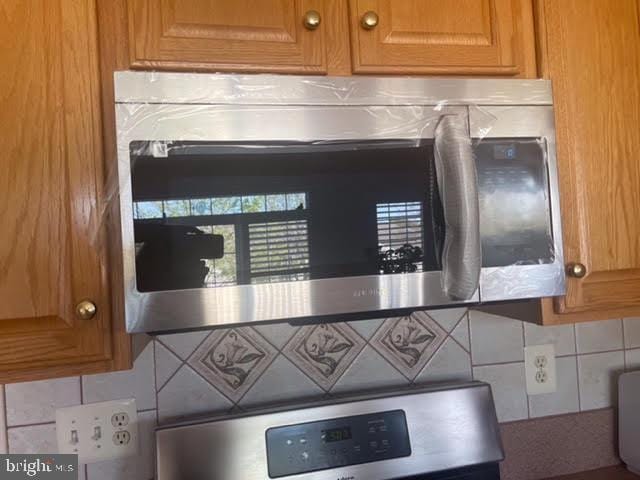 detailed view of stainless steel microwave and backsplash