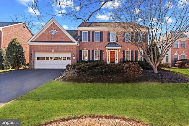 view of front of property featuring a garage and a front lawn