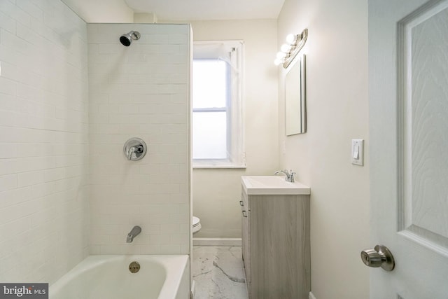 full bathroom featuring vanity, tiled shower / bath combo, and toilet