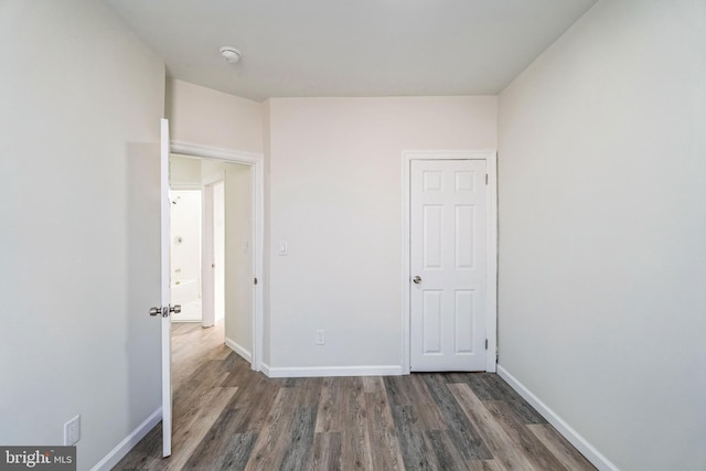 unfurnished bedroom featuring dark hardwood / wood-style floors