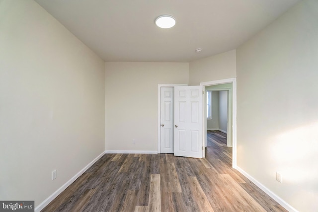 spare room with dark wood-type flooring