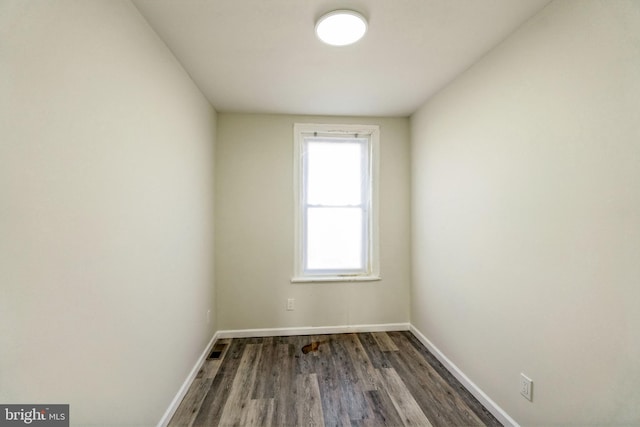 spare room with dark wood-type flooring