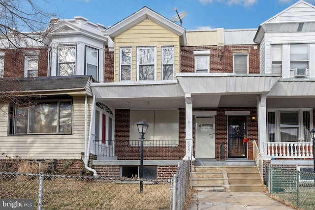 townhome / multi-family property featuring cooling unit and covered porch