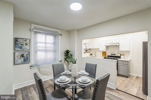 dining space featuring light wood-type flooring