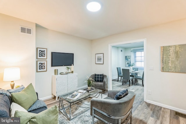 living room with light hardwood / wood-style flooring