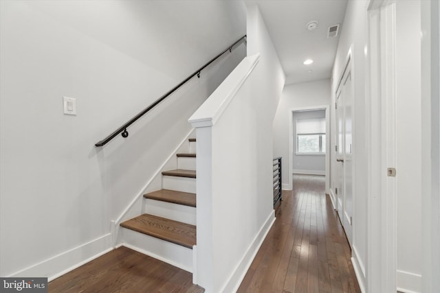 stairs featuring hardwood / wood-style flooring