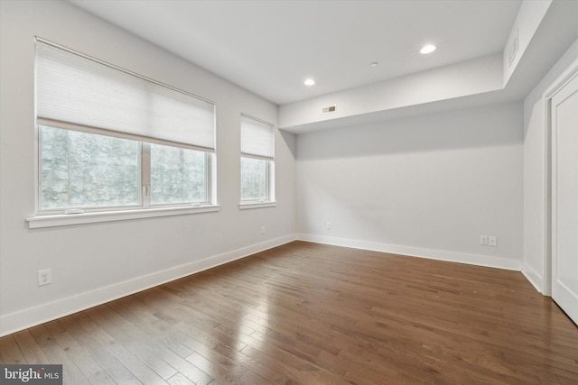 spare room with dark wood-type flooring