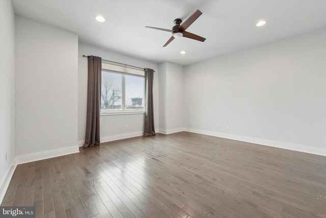 spare room with wood-type flooring and ceiling fan