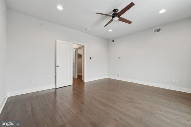 spare room with dark hardwood / wood-style floors and ceiling fan