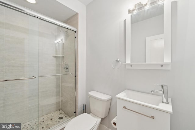 bathroom with vanity, toilet, and a shower with shower door