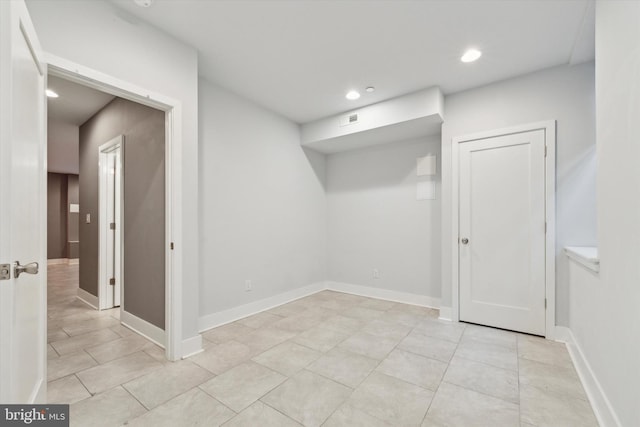 basement featuring light tile patterned floors