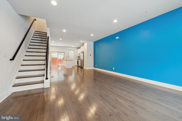 unfurnished living room featuring hardwood / wood-style flooring