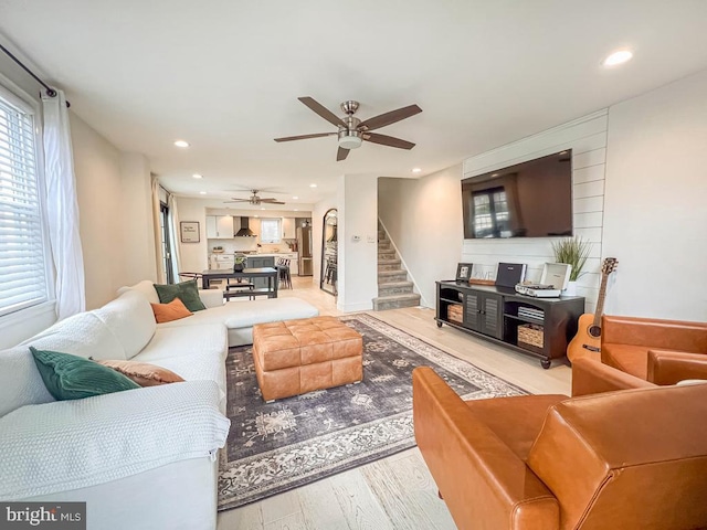 living room featuring hardwood / wood-style flooring and ceiling fan