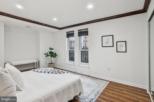 bedroom featuring recessed lighting, dark wood-style flooring, crown molding, and baseboards