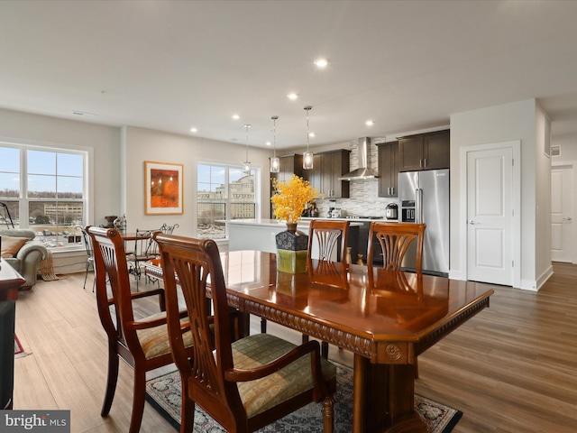 dining space featuring plenty of natural light and light wood-type flooring