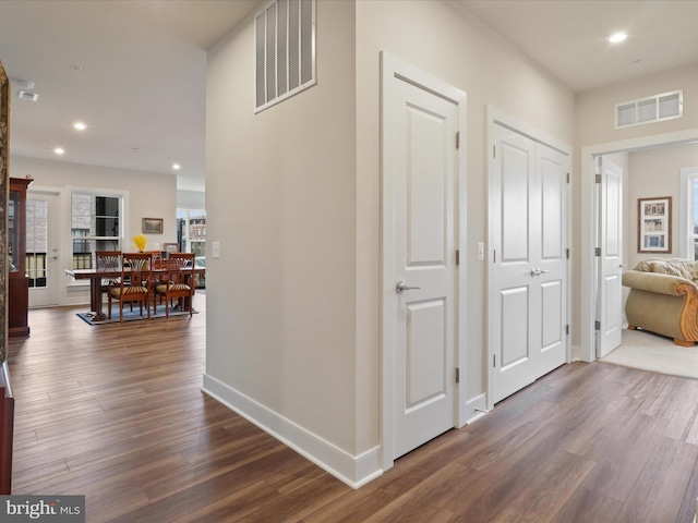 hallway with dark hardwood / wood-style flooring