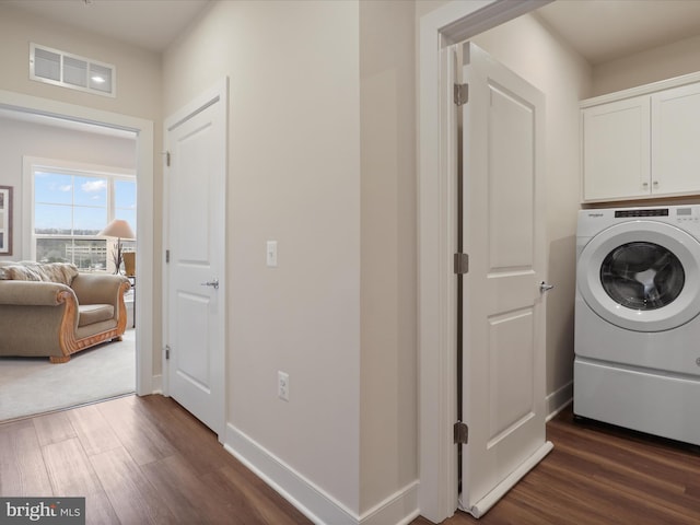 washroom with cabinets, dark hardwood / wood-style floors, and washer / clothes dryer