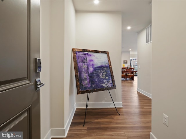 corridor with hardwood / wood-style floors