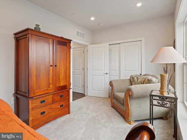 sitting room featuring light colored carpet