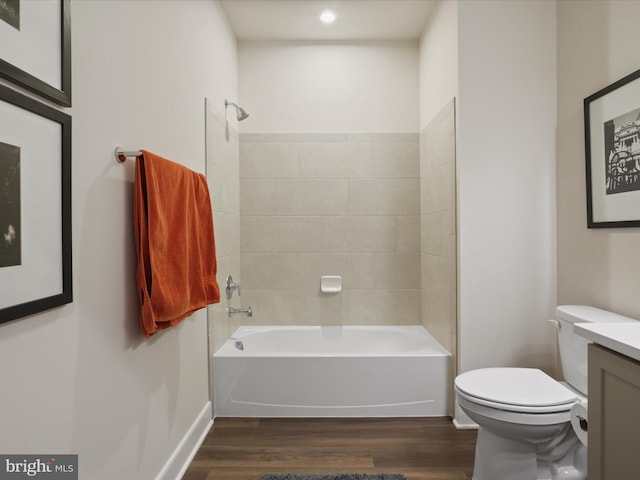 full bathroom with vanity, toilet, tiled shower / bath combo, and hardwood / wood-style floors