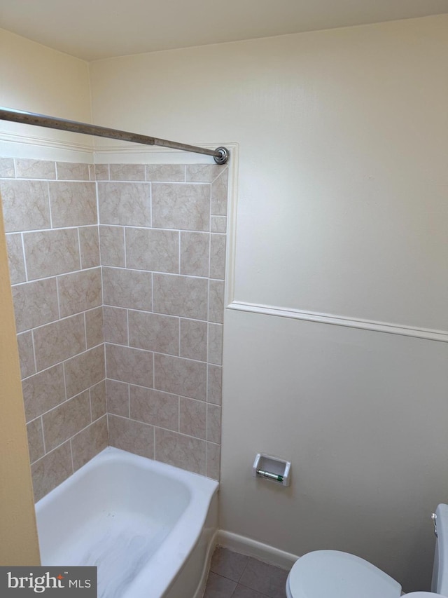 full bathroom featuring baseboards,  shower combination, toilet, and tile patterned floors