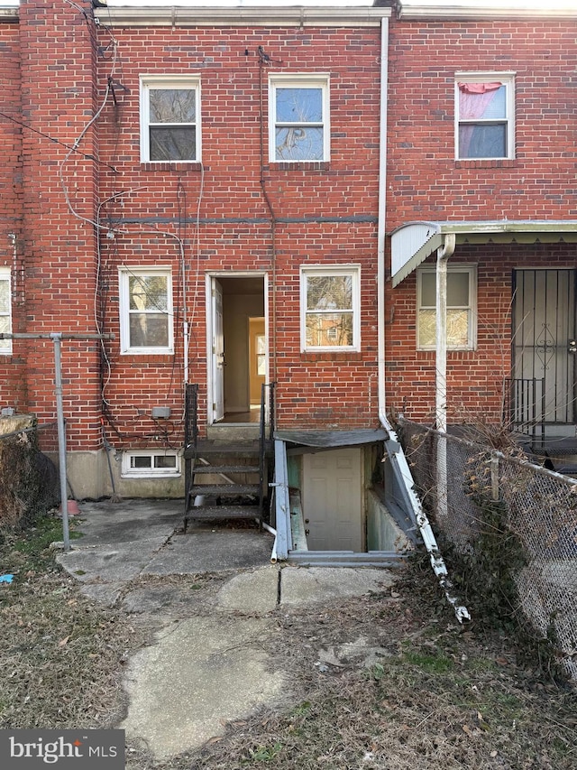 back of house featuring brick siding