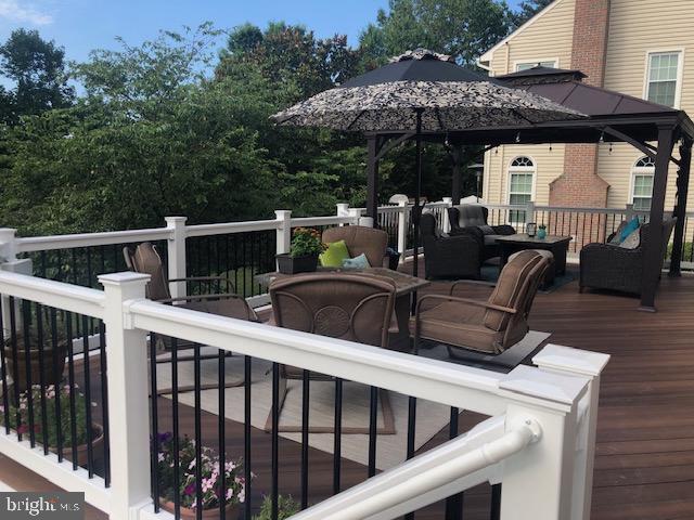 deck with a gazebo and an outdoor hangout area